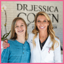 Dr Jessica Cohen hugging a patient in a blue shirt