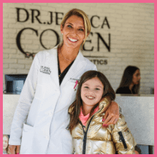 Dr Jessica Cohen hugging a patient in a gold coat