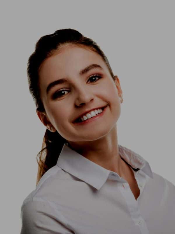 Young woman showing off flawless smile after orthodontic treatment